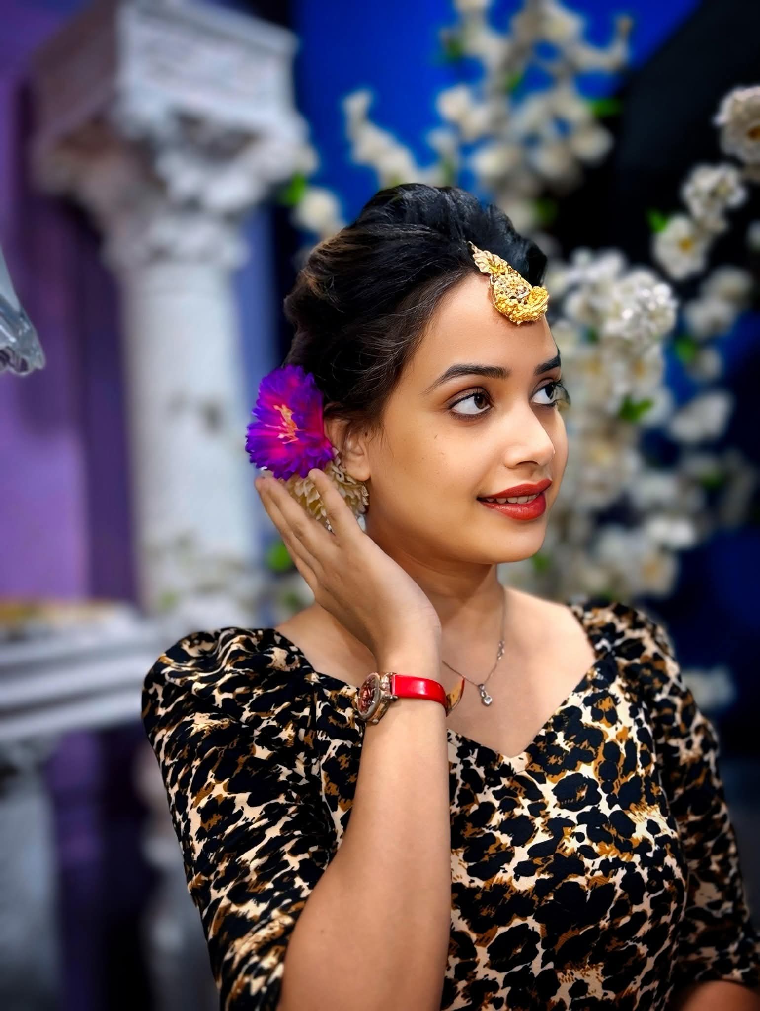Party makeup with gold tikka and floral hair
