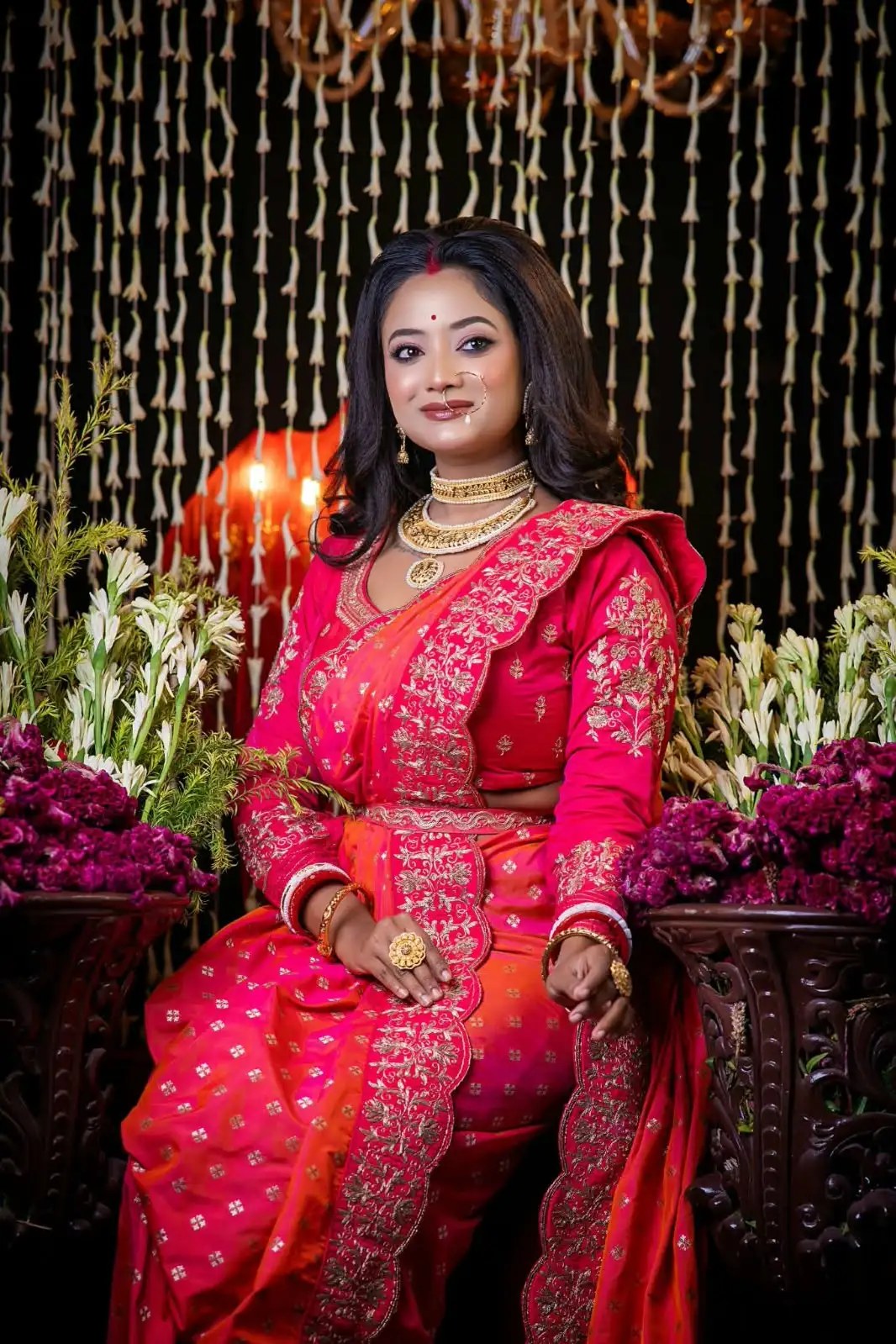Bride seated in red and gold attire